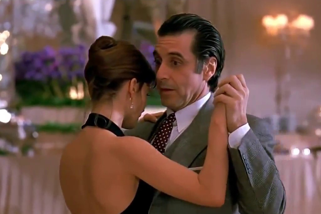 A blind man and a beautiful lady dancing in the room